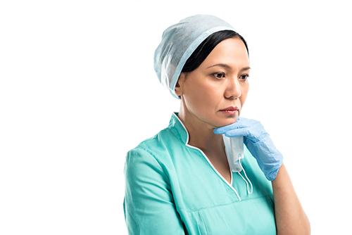 Nurse looking off into distance in concern