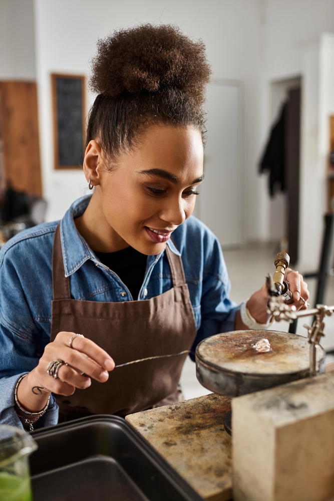 An artisan focuses intently on creating intricate jewelr