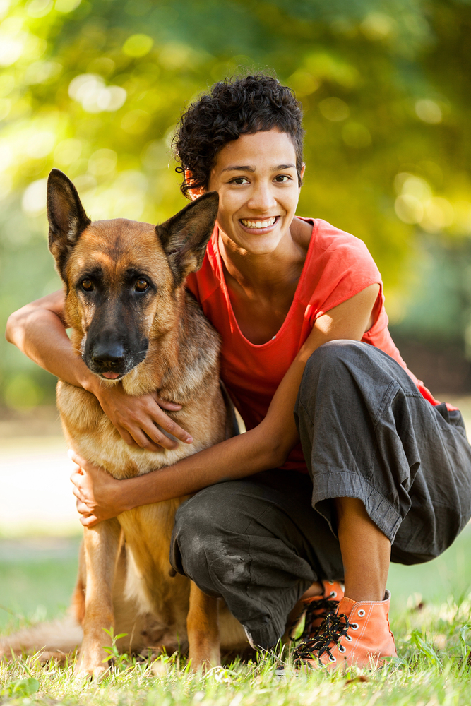 Portrait of woman with german shepherd